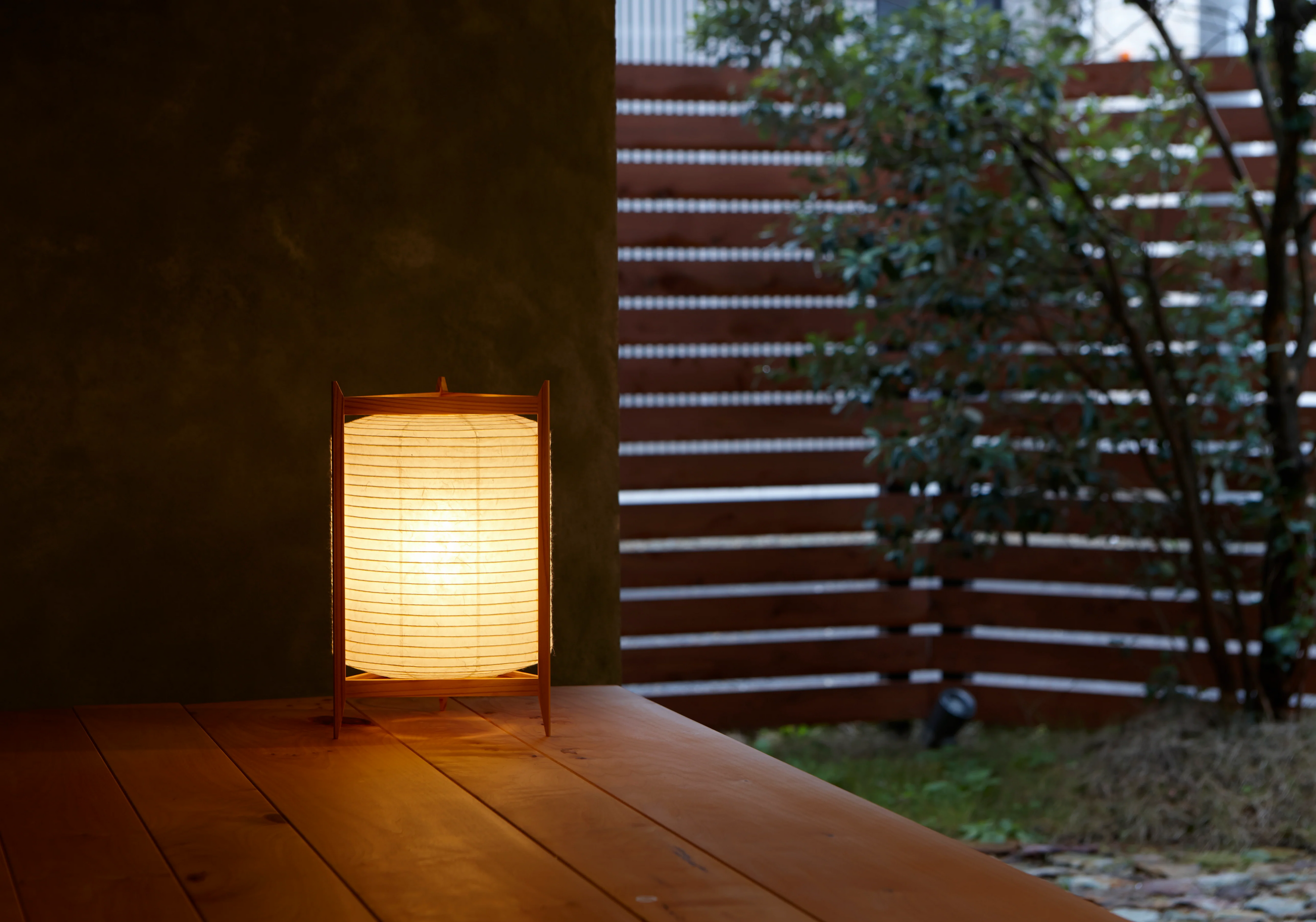 Andon Triangle Japanese paper lamp on a porch at dusk