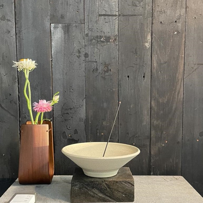 Japanese bamboo incense burning in a clay burner