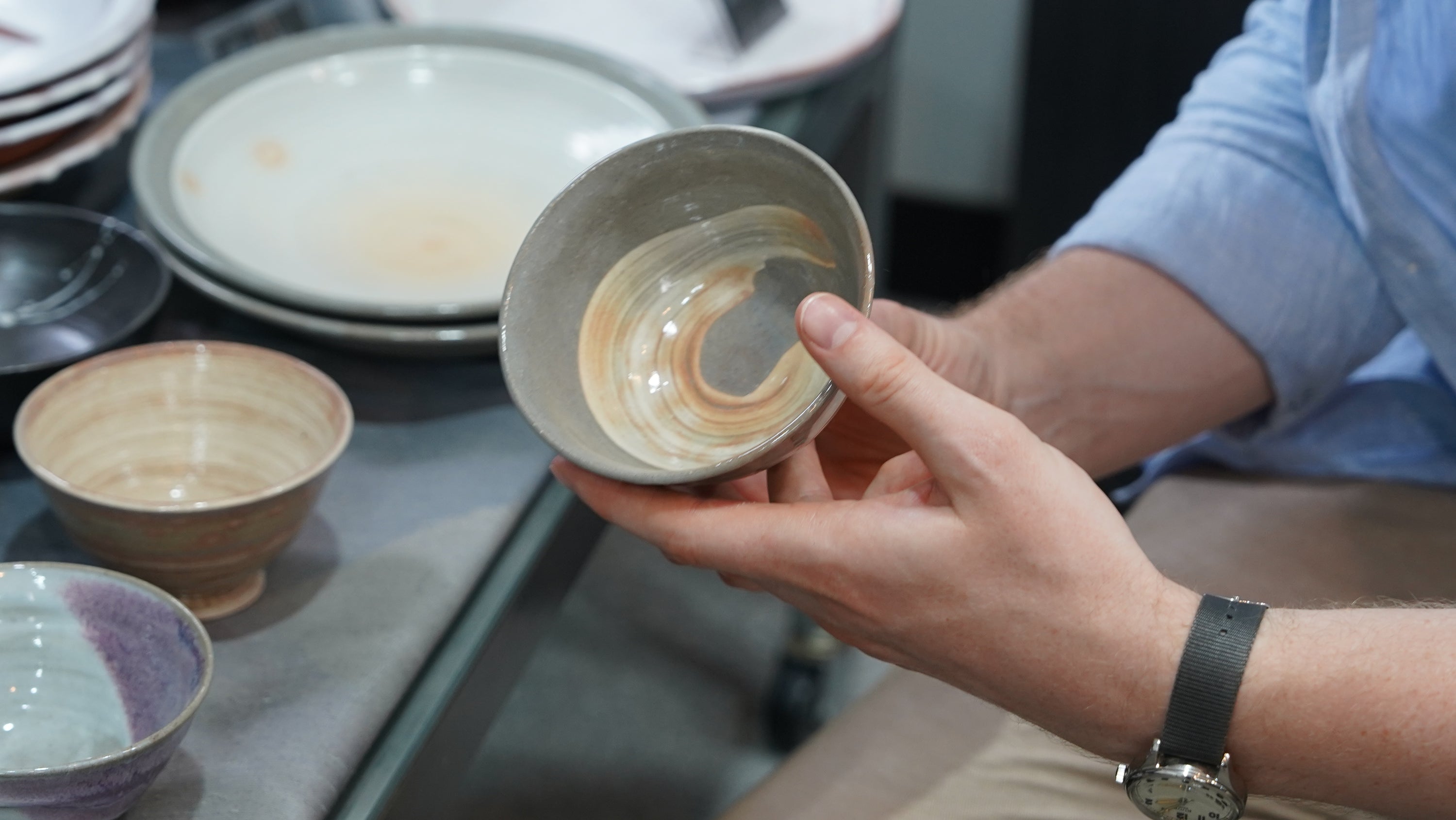 Hands holding a Hagi yaki bowl in Hagi, Japan