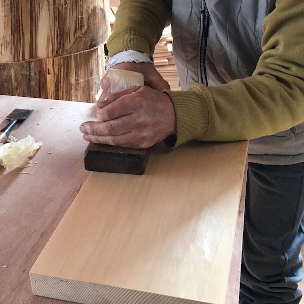 A Cul de Sac craftsman planing a hiba wood chopping board