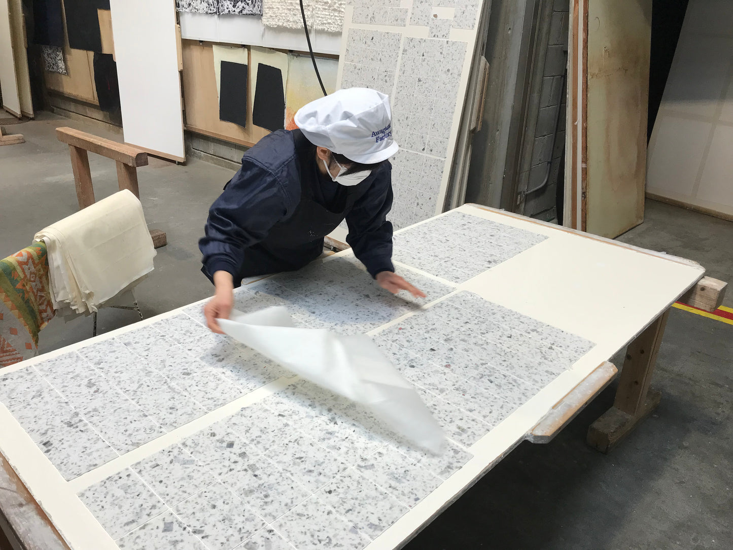 Awagami Factory artisan laying out washi paper cards to dry
