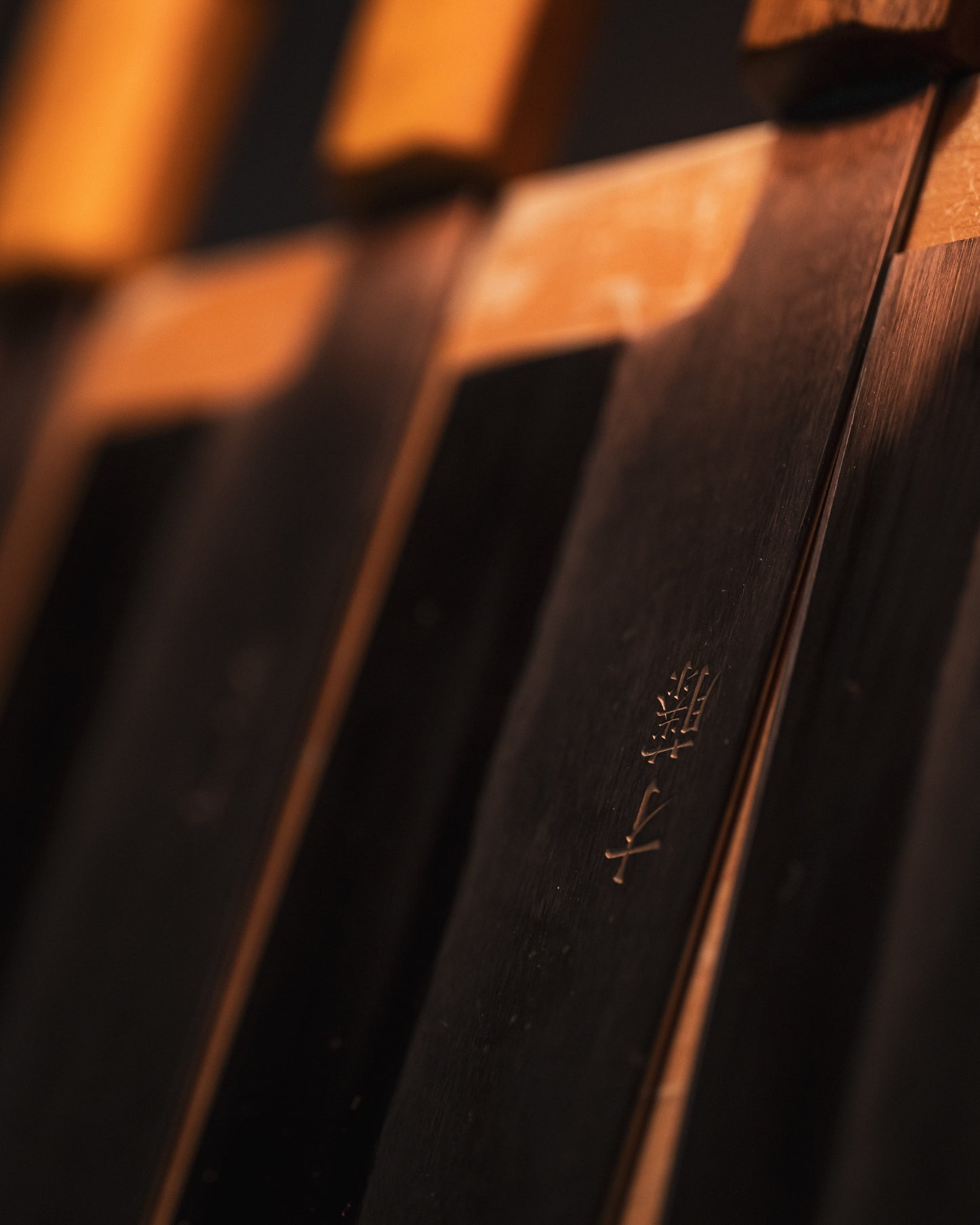 Close up of Masaaki Saito Japanese knives on a knife rack