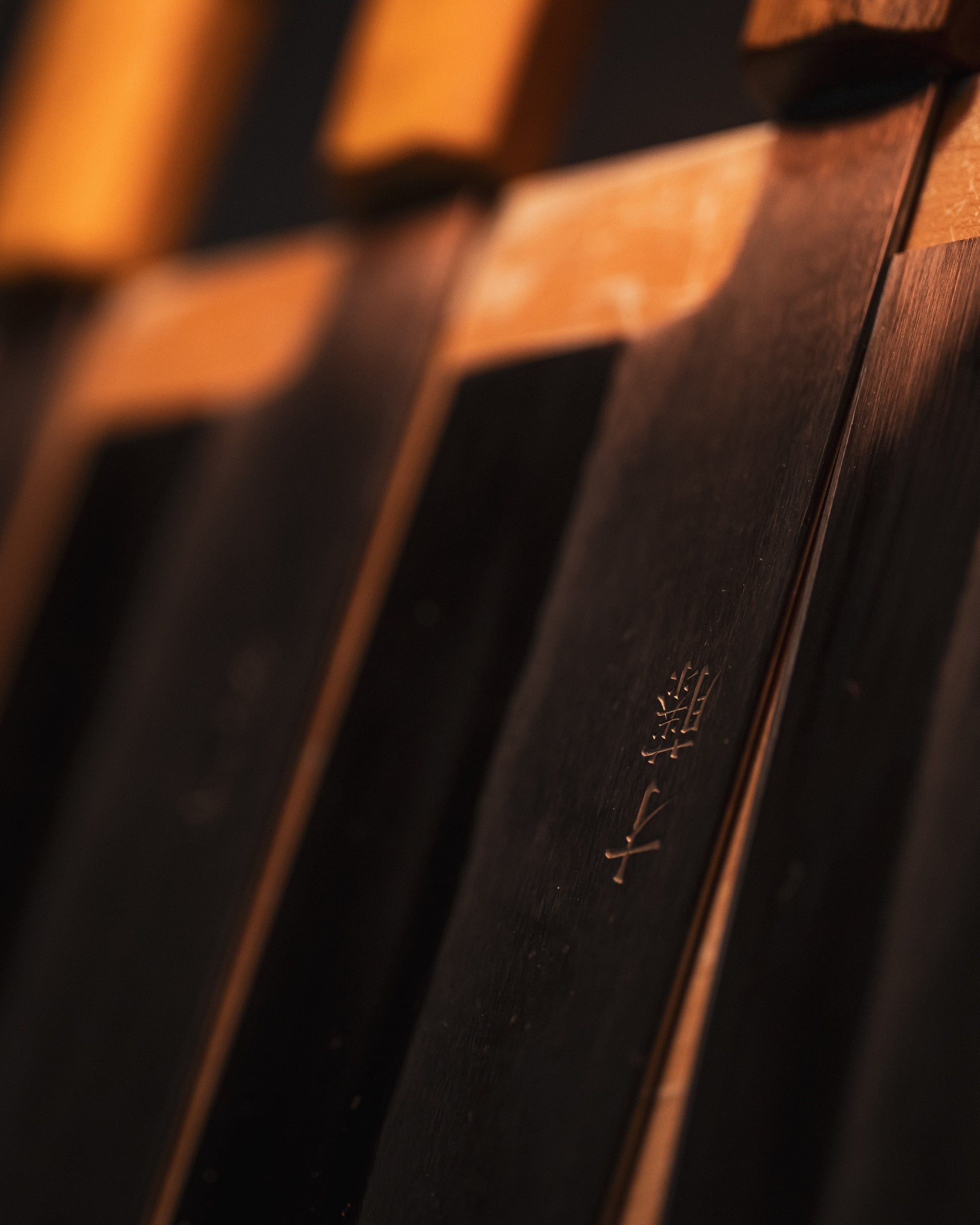 Close up of Masaaki Saito Japanese knives on a knife rack