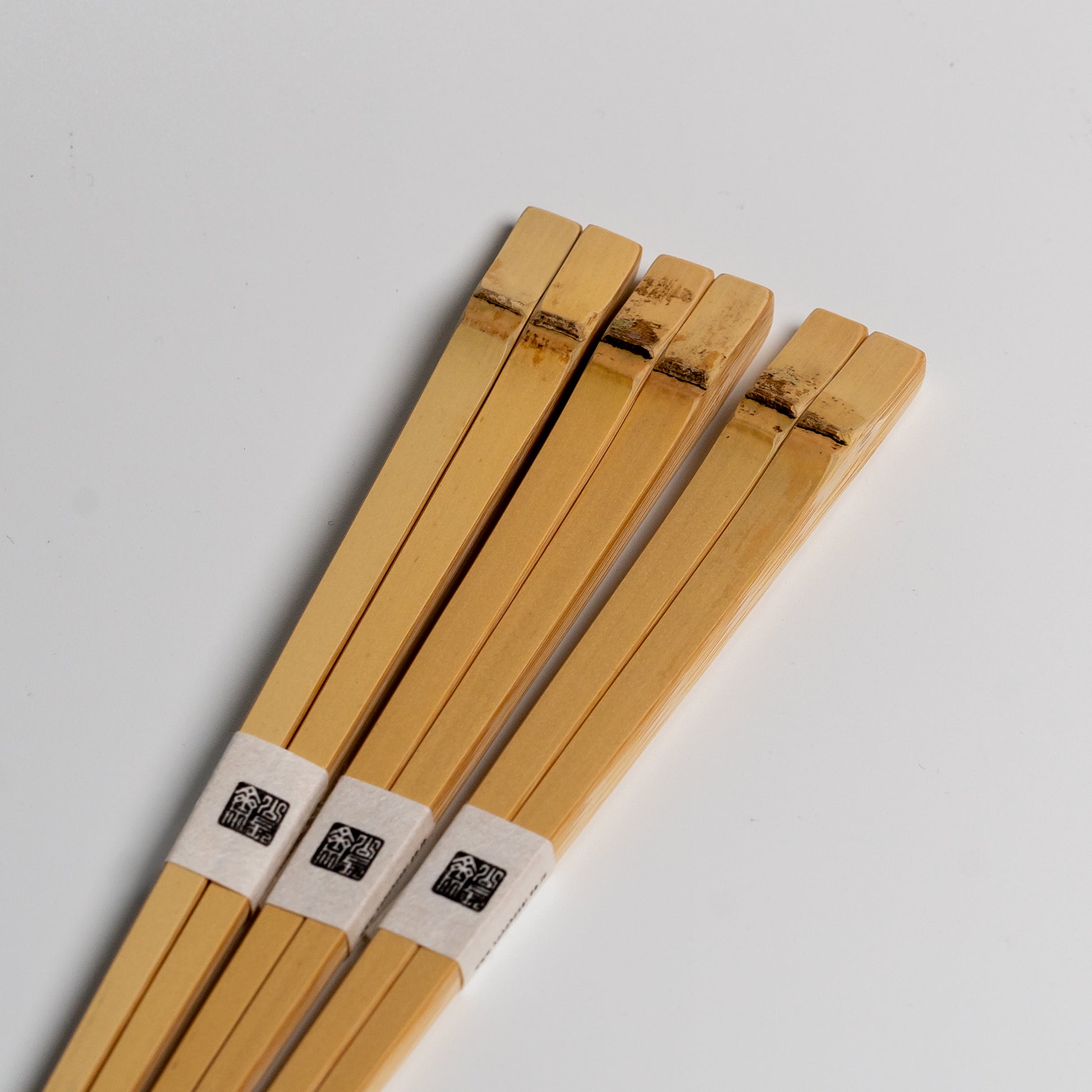 The tops of three Japanese bamboo chopsticks