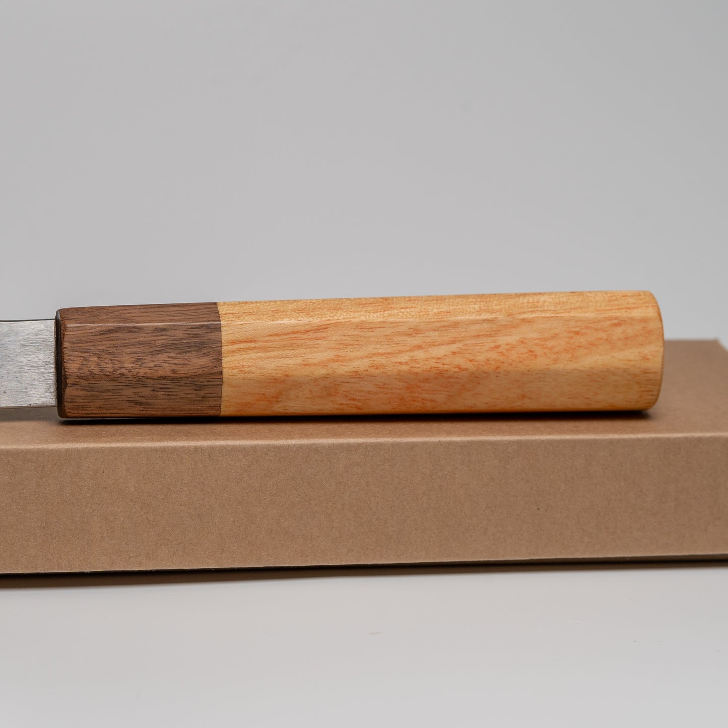 Close up of the handle of a Japanese Nakiri knife on its box