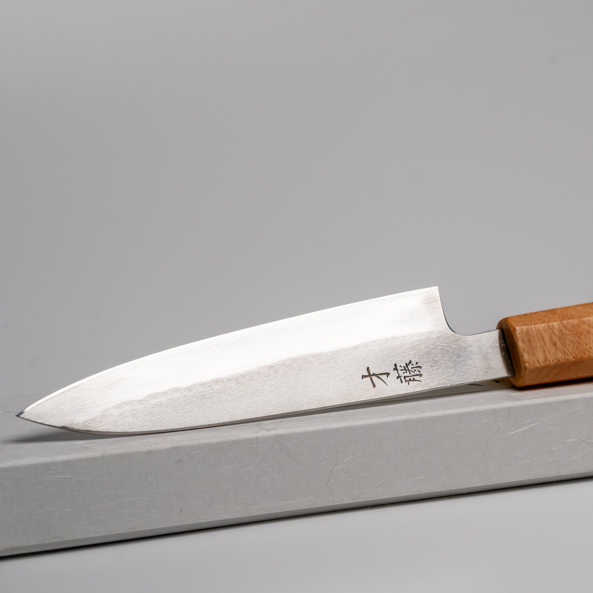 Close up of Japanese paring knife on its box
