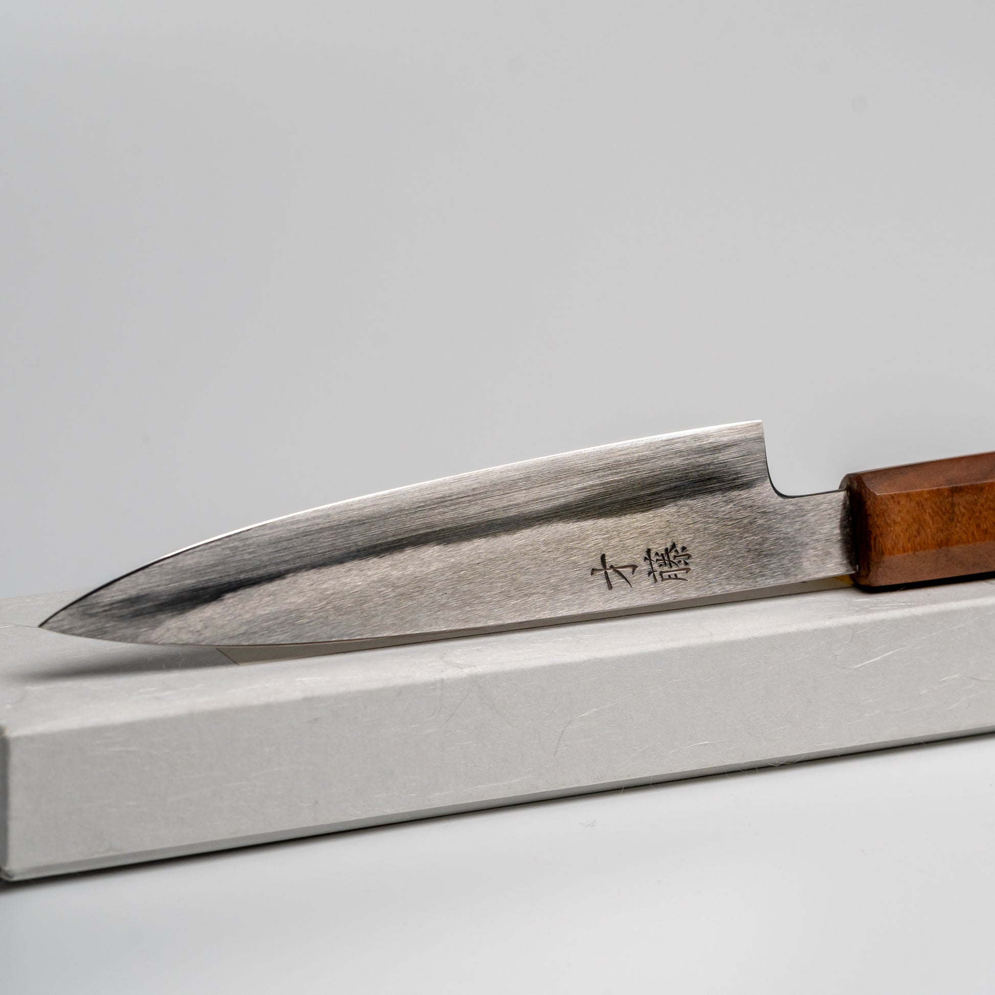 Close up of Japanese paring knife on its box