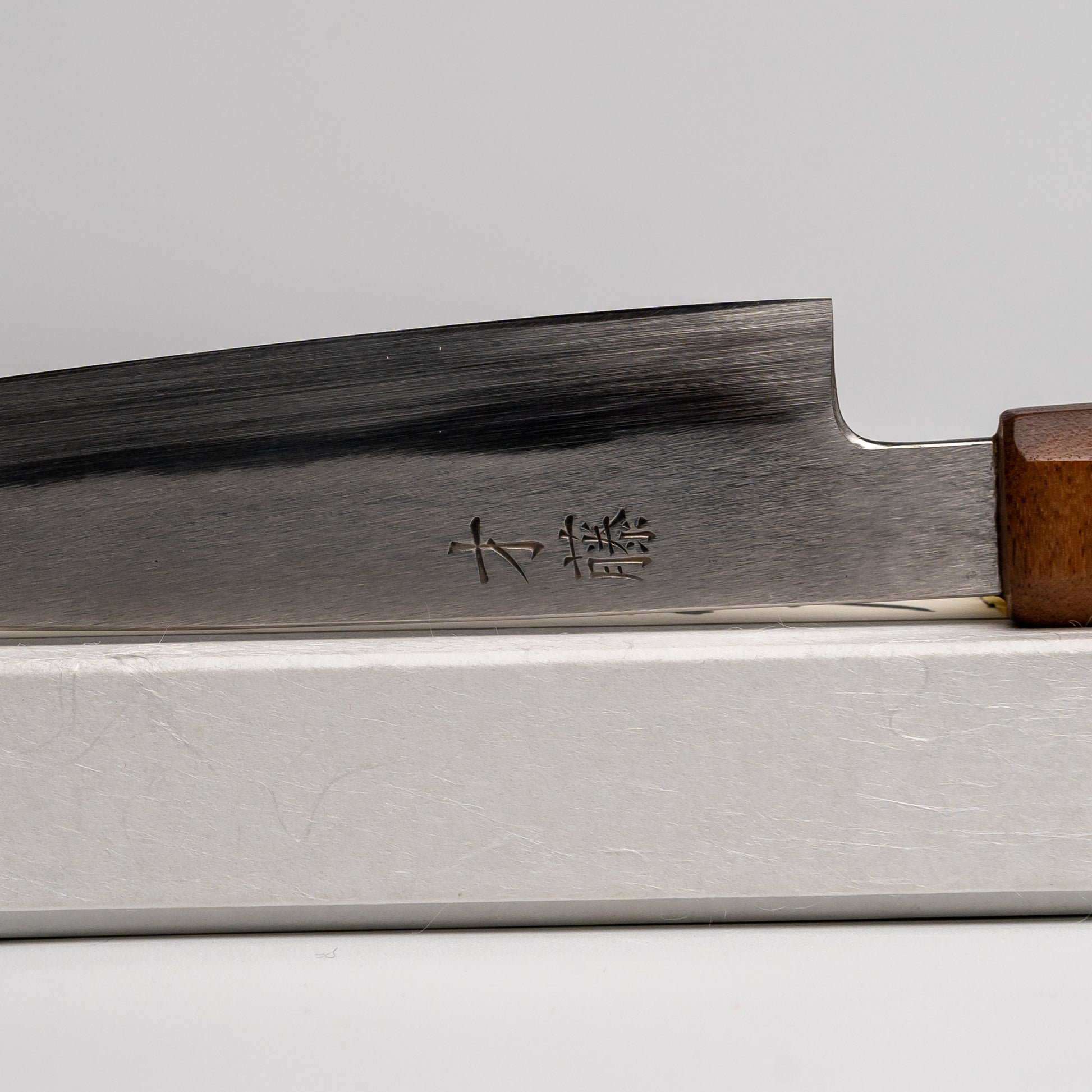 Close up of Japanese paring knife on its box