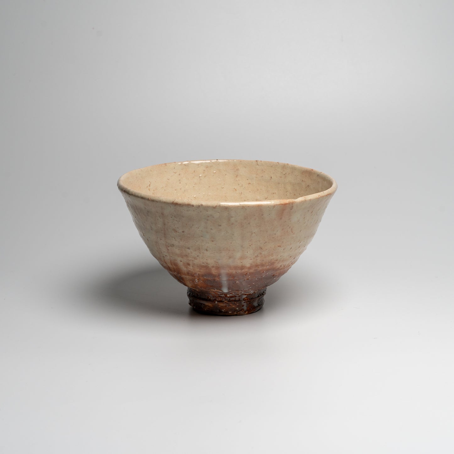 A Japanese ceramic ceremonial matcha tea bowl on a white background