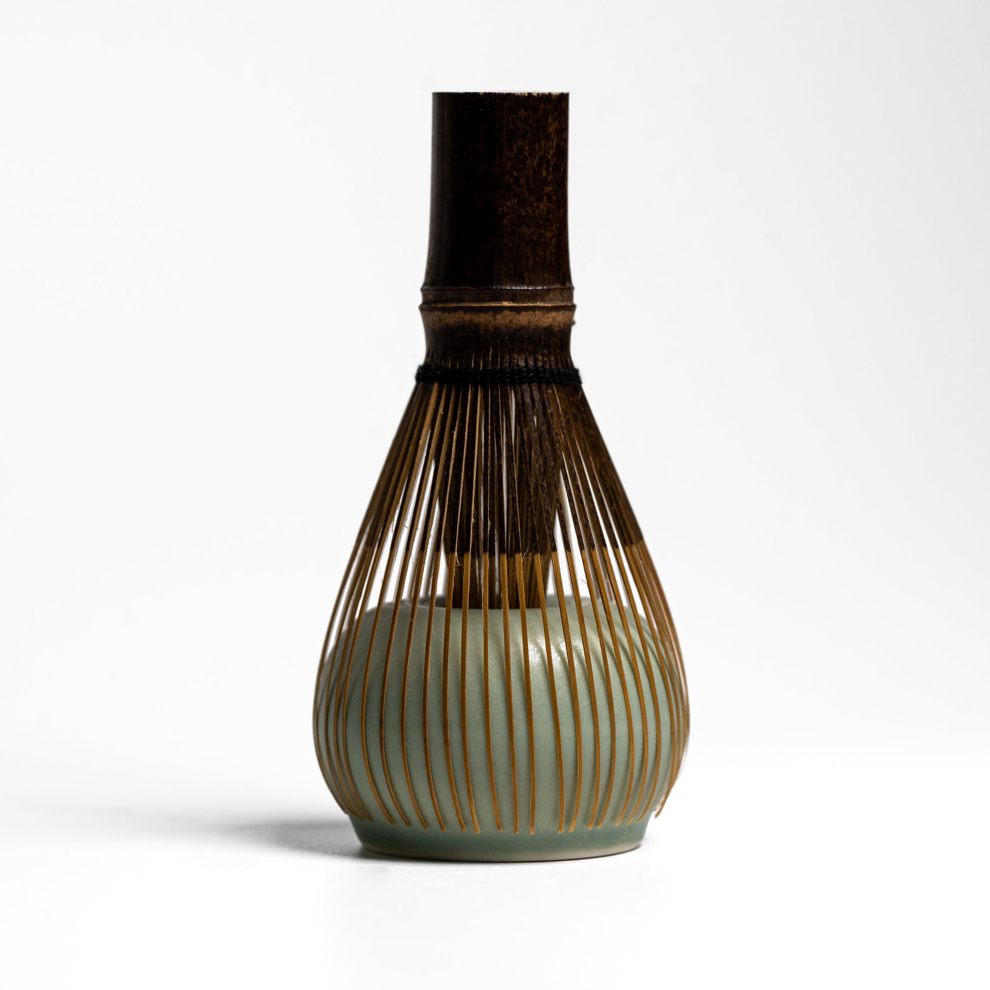 ORIGAMI matcha whisk stand holding a chasen matcha whisk