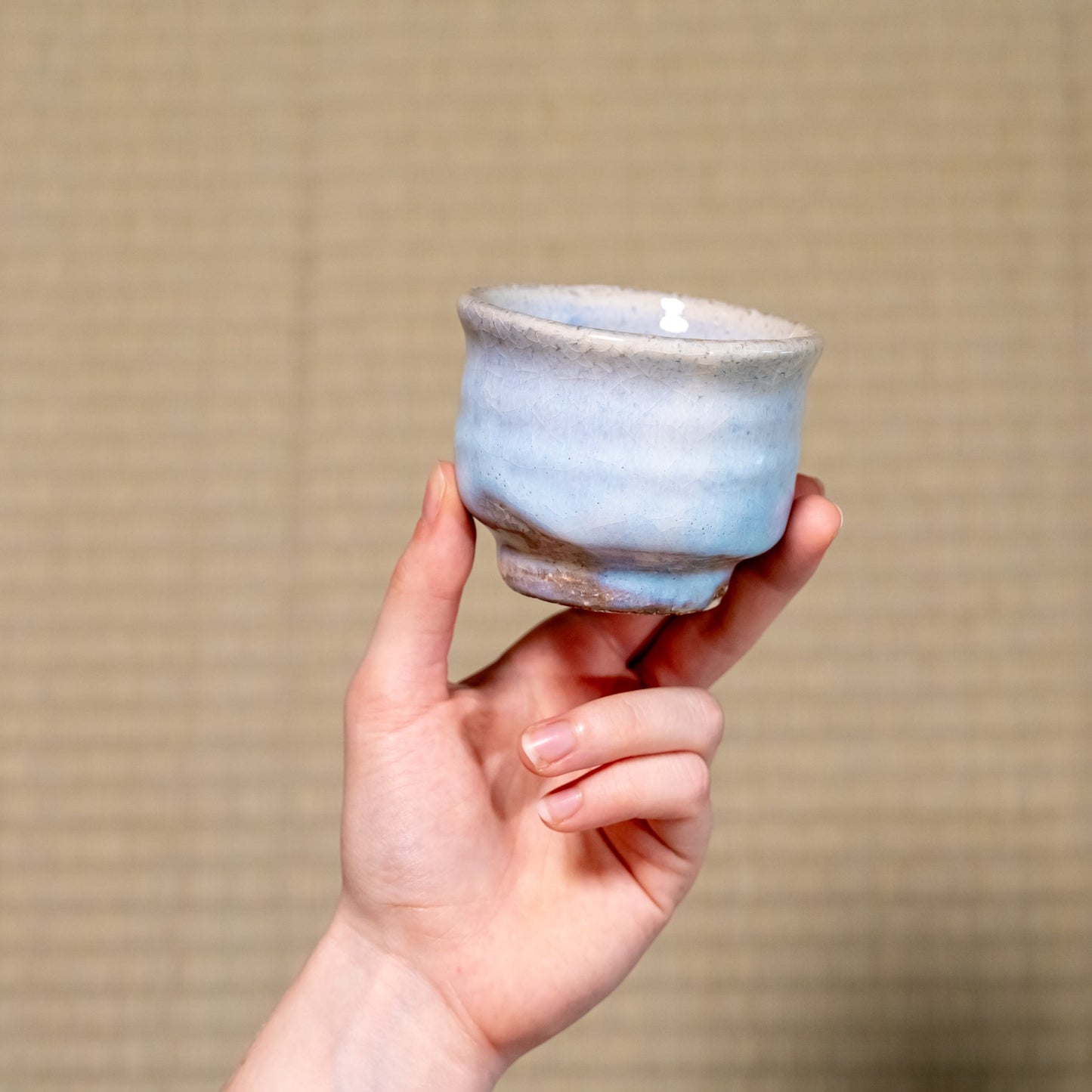 A Japanese ceramic Hagi yaki teacup held in hand