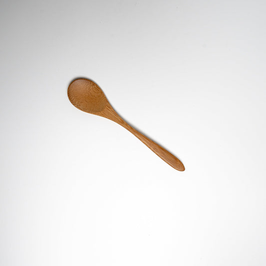 A Japanese bamboo spoon on a white background