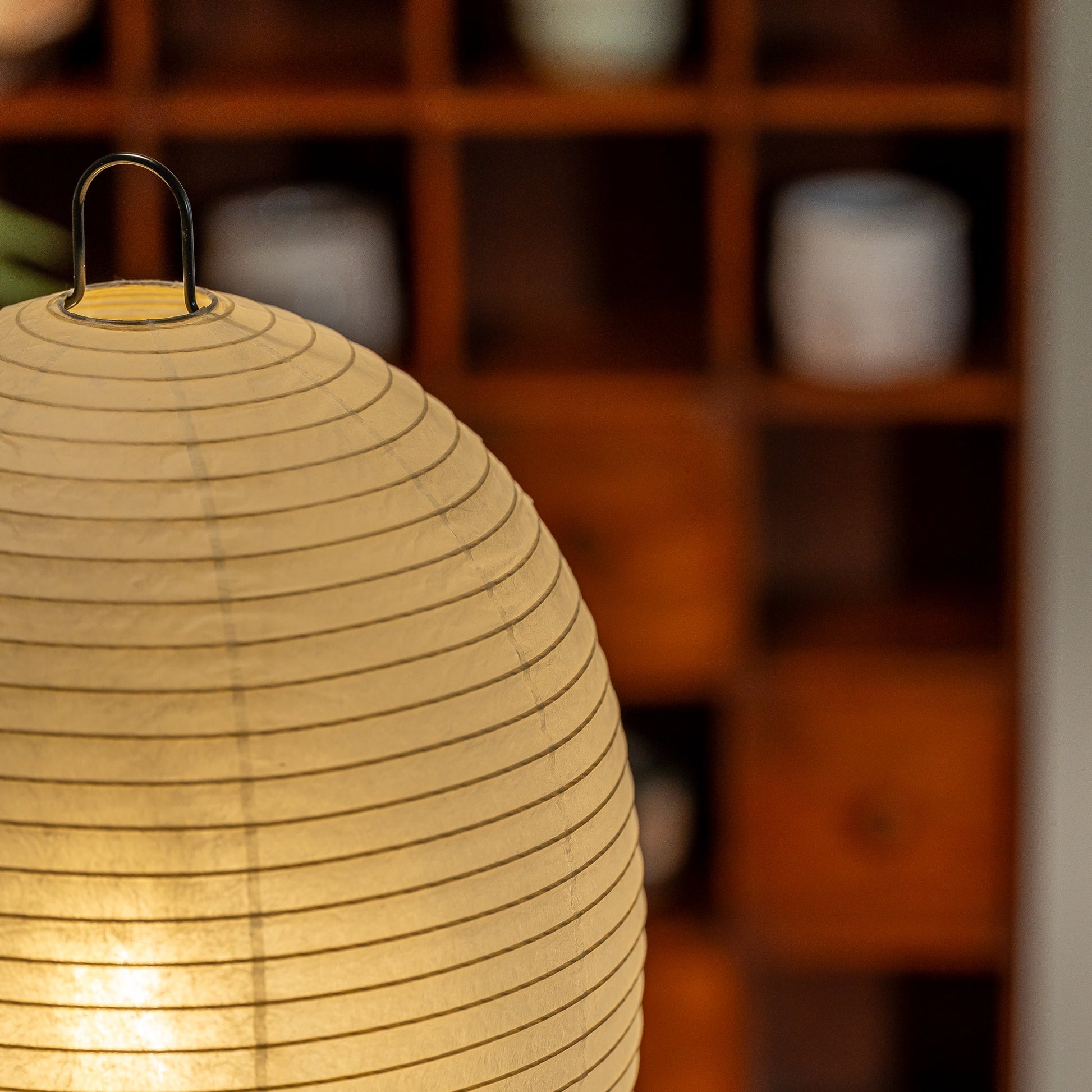 Close up of a switched on Chochin paper lamp