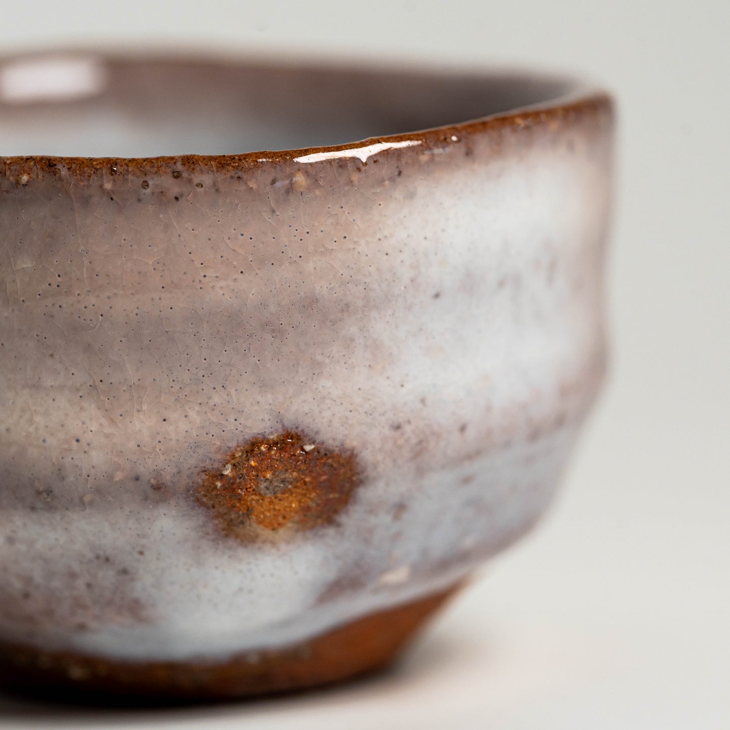 A close up of a pink and white Hagi yaki sake cup