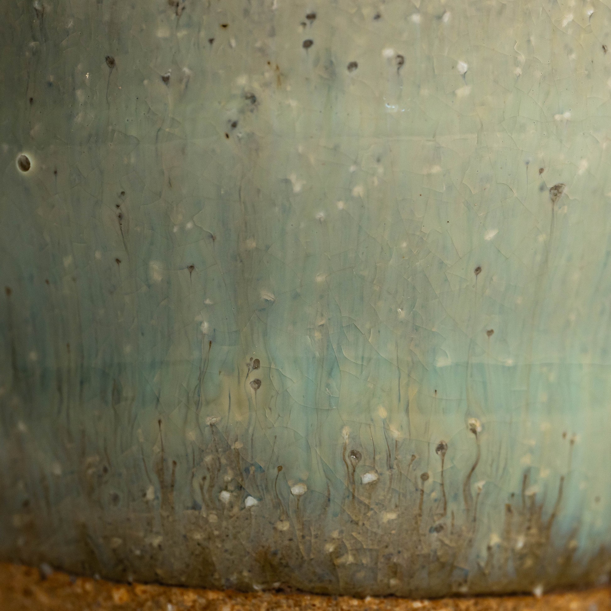 A close up of a green Hagi yaki shochu cup's glaze