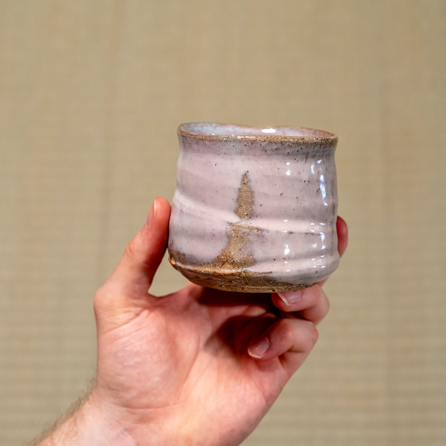 A Japanese ceramic Hagi yaki cup held in hand