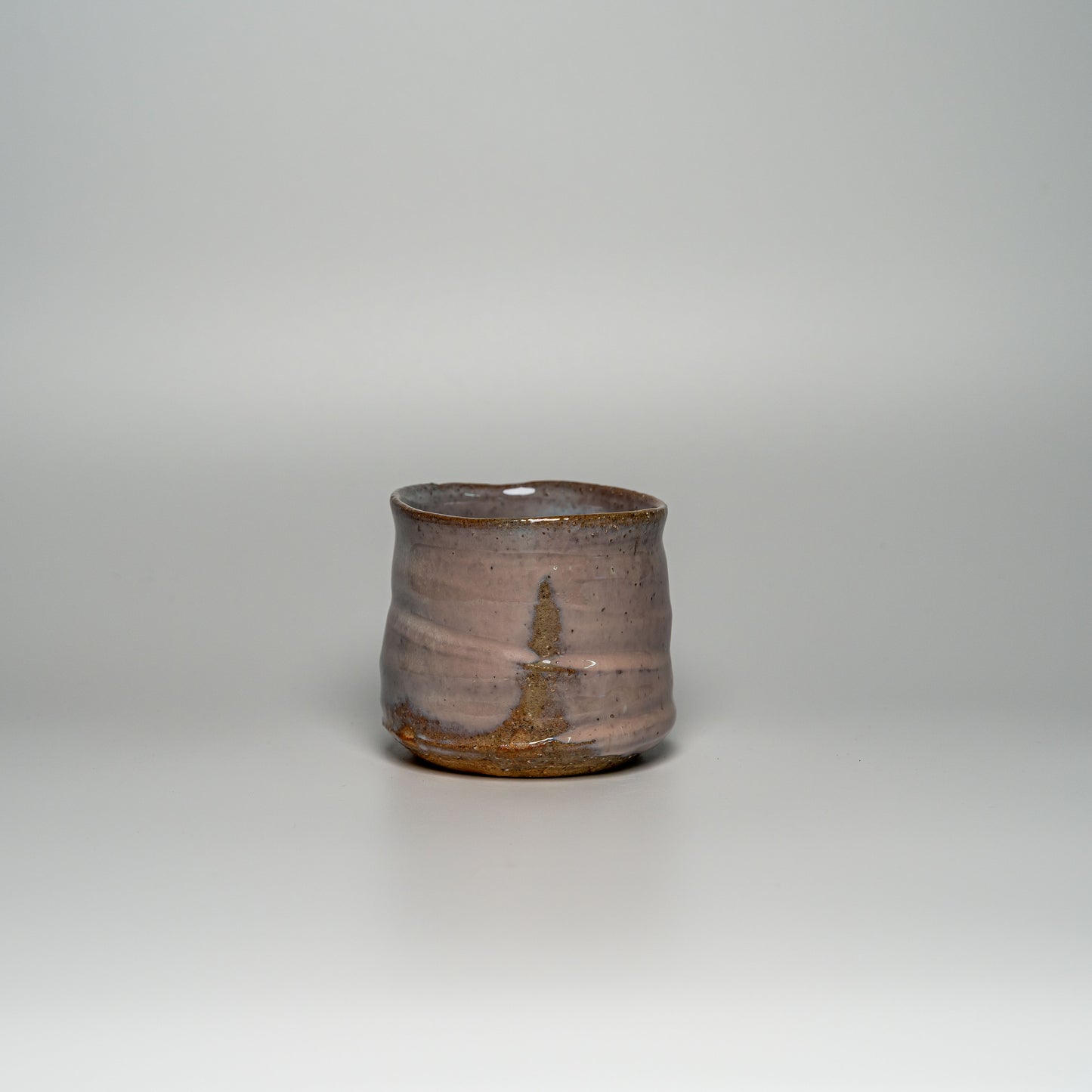 A pink Hagi yaki shochu cup on a white background