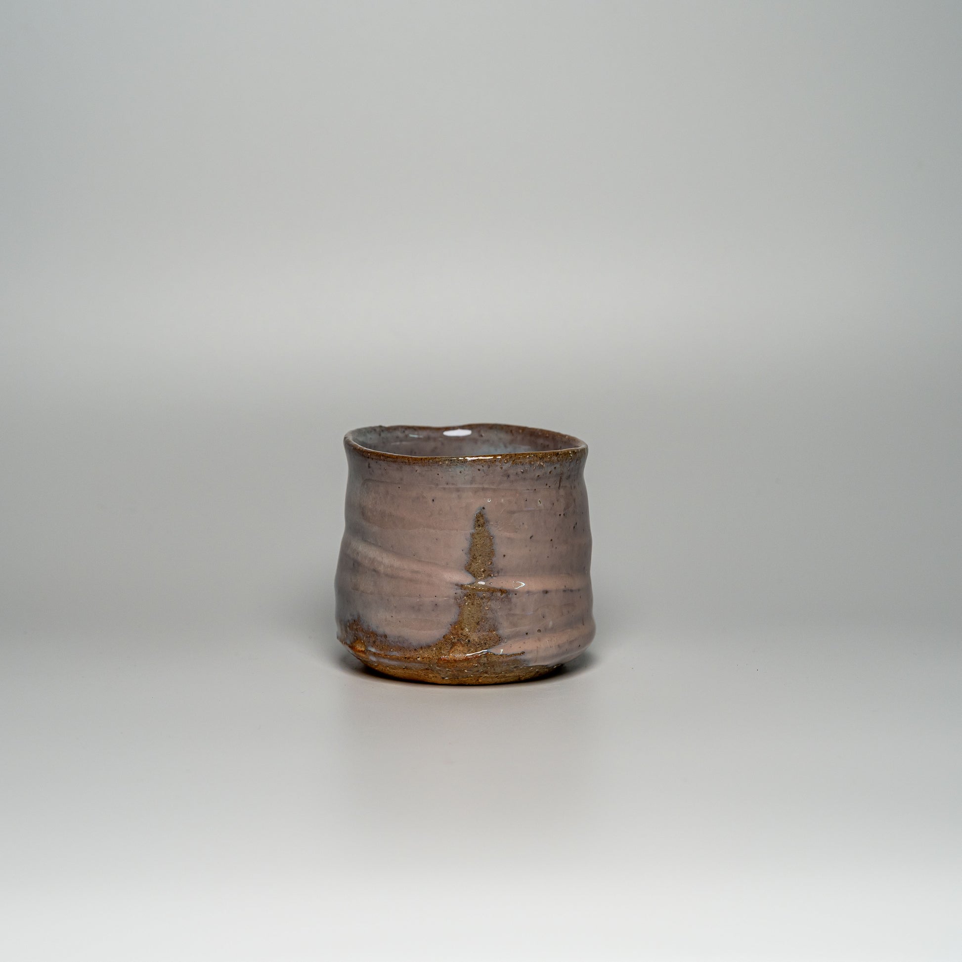 A pink Hagi yaki shochu cup on a white background