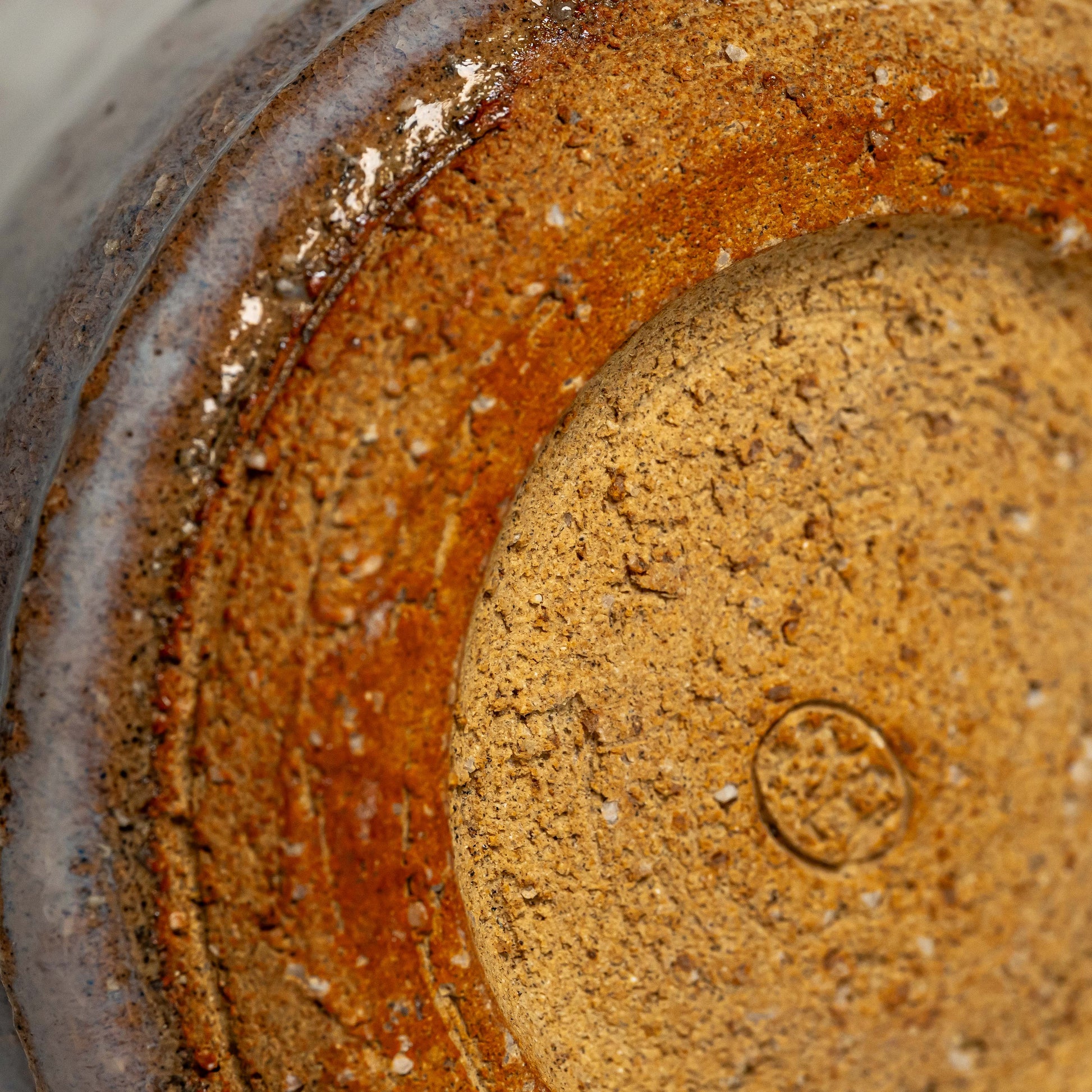 A close up of the bottom of a white Hagi yaki shochu cup