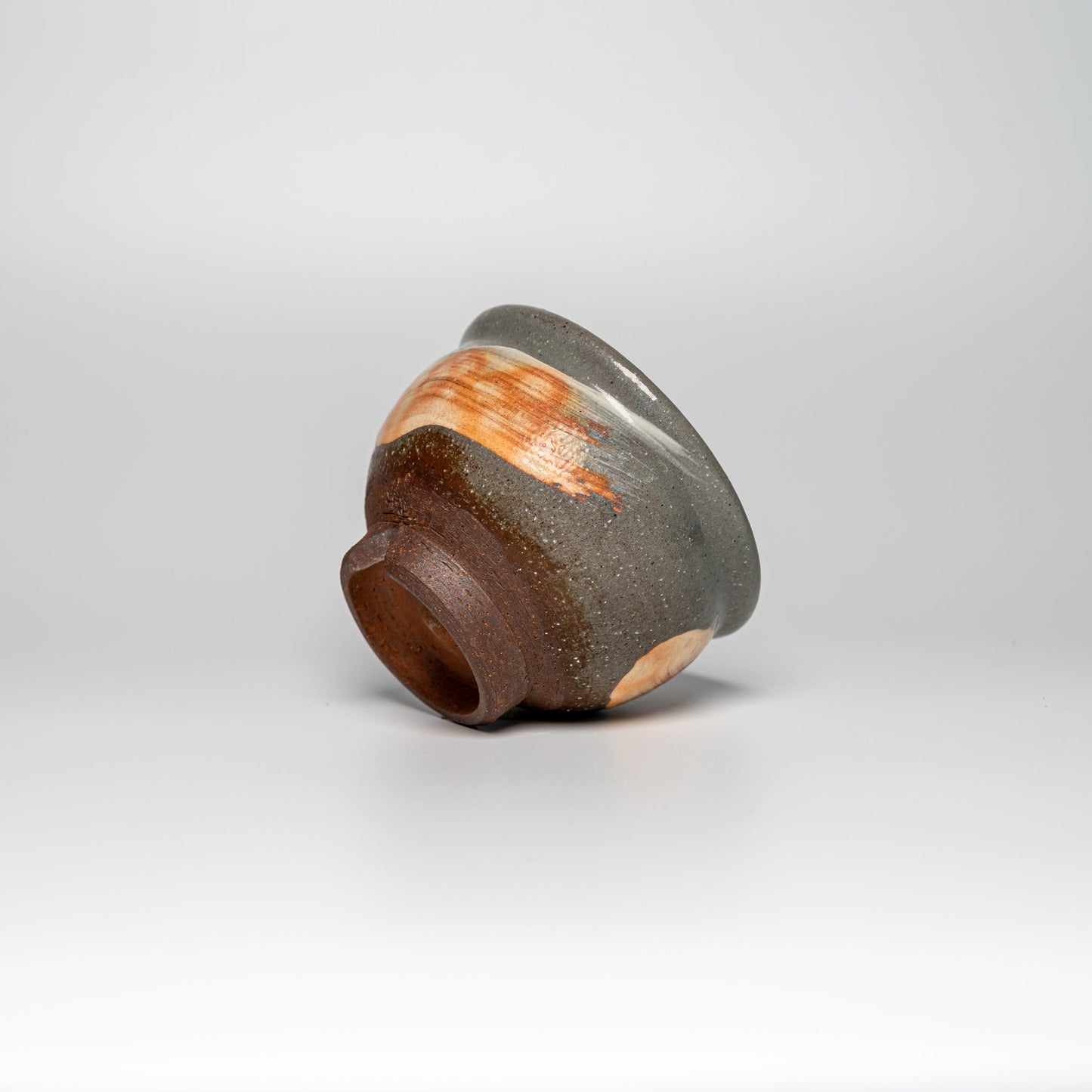 A small Hagi yaki bowl on its side on a white background