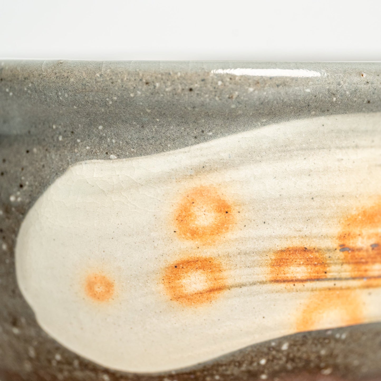 A close up of a small Hagi yaki bowl on a white background