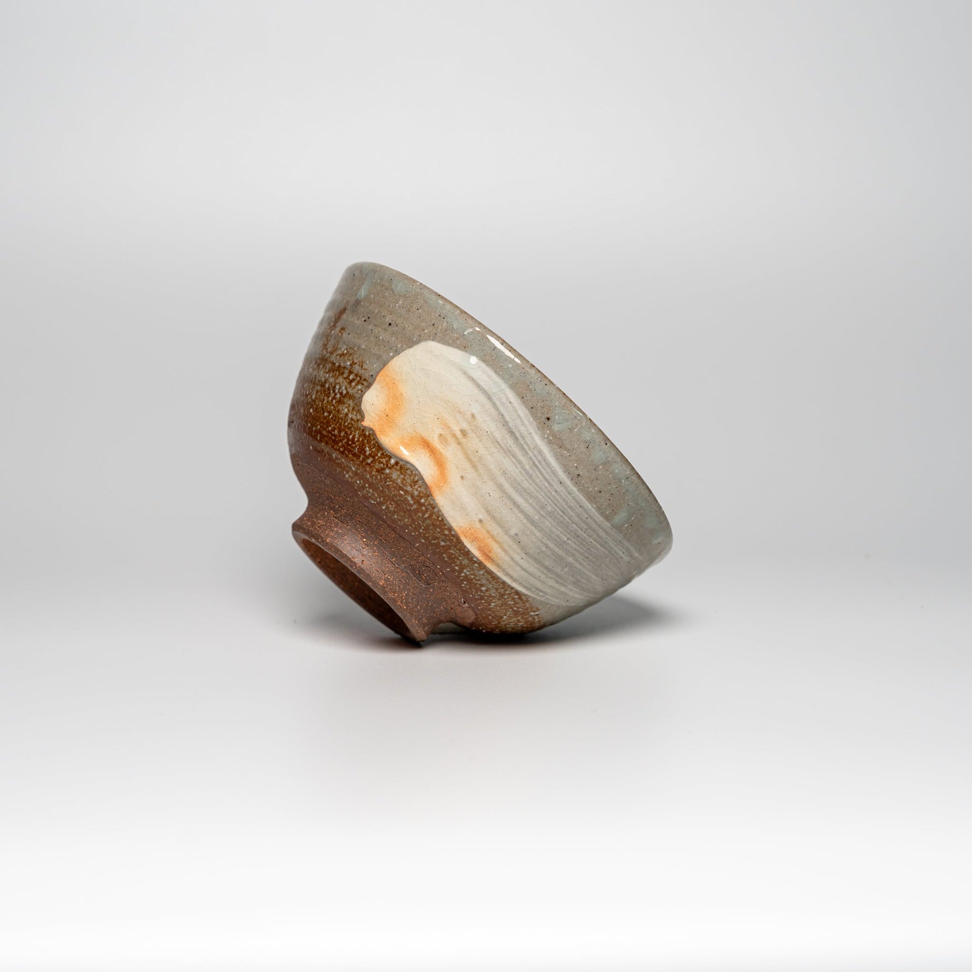 The side of a Japanese Hagi yaki rice bowl on a white background