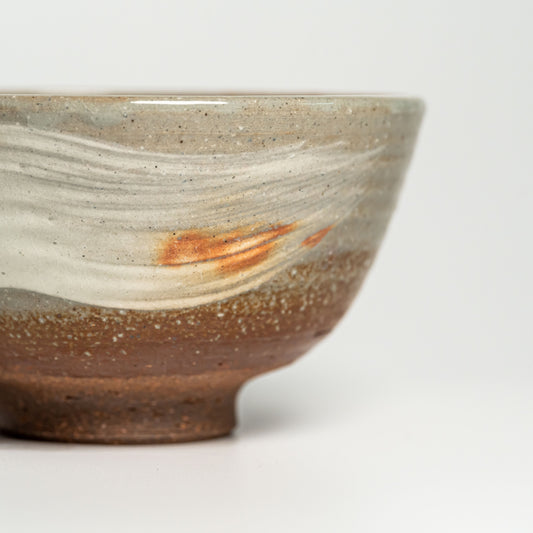 A close up of a Japanese Hagi yaki rice bowl on a white background