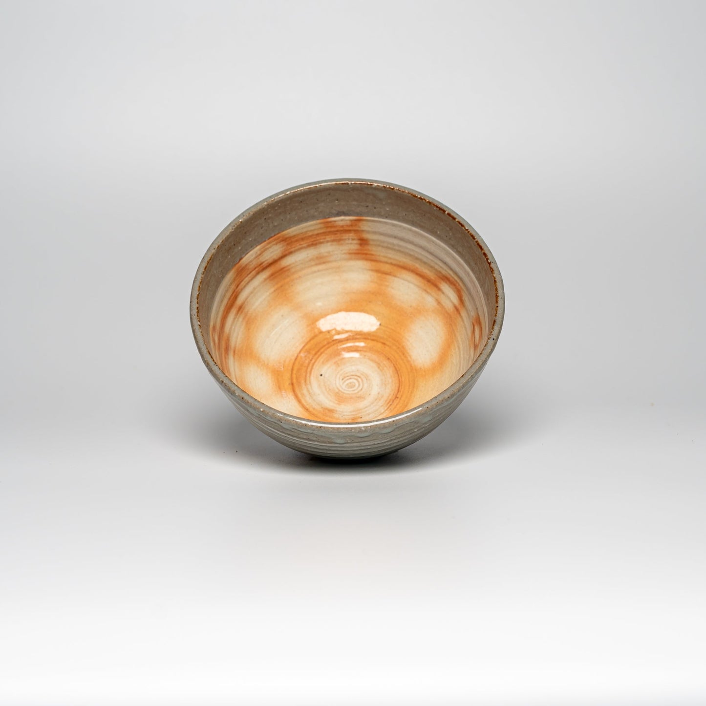 The inside of a Japanese Hagi yaki rice bowl on a white background