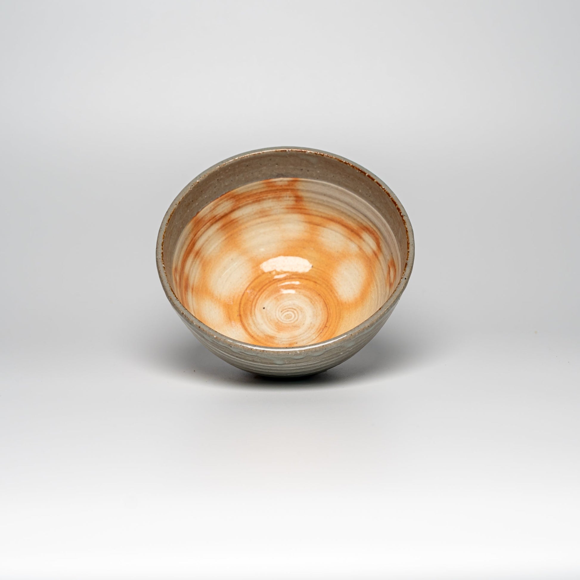 The inside of a Japanese Hagi yaki rice bowl on a white background