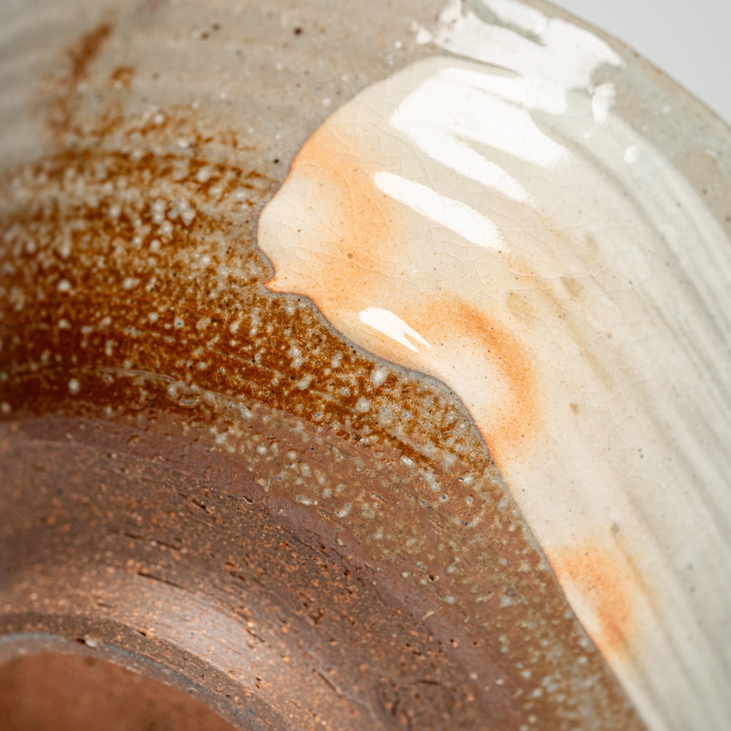 A close up of the bottom of a Japanese Hagi yaki rice bowl on a white background