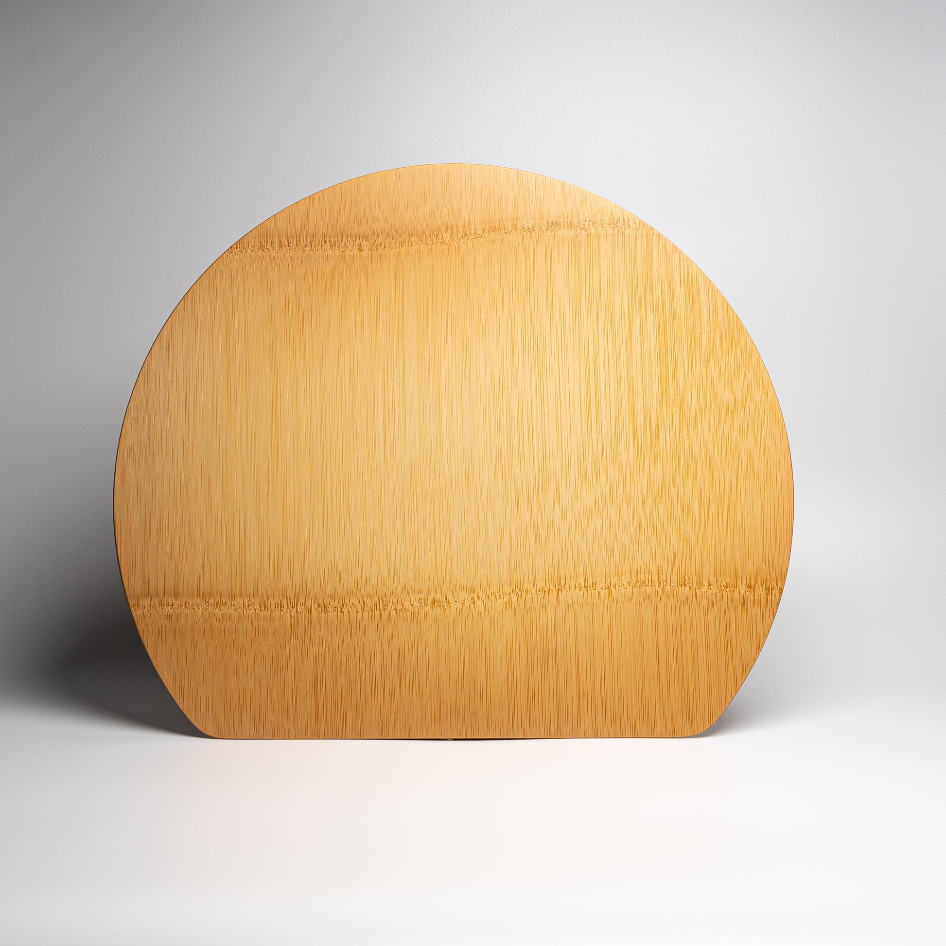 A bamboo half moon placemat on a white background