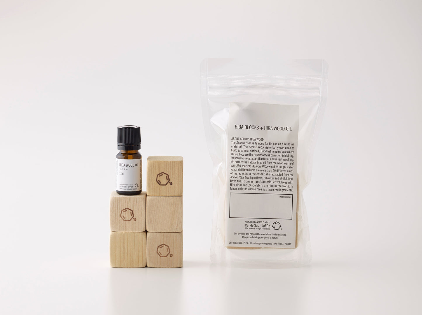A packet of Cul de Sac hiba wood blocks and oil on a white background