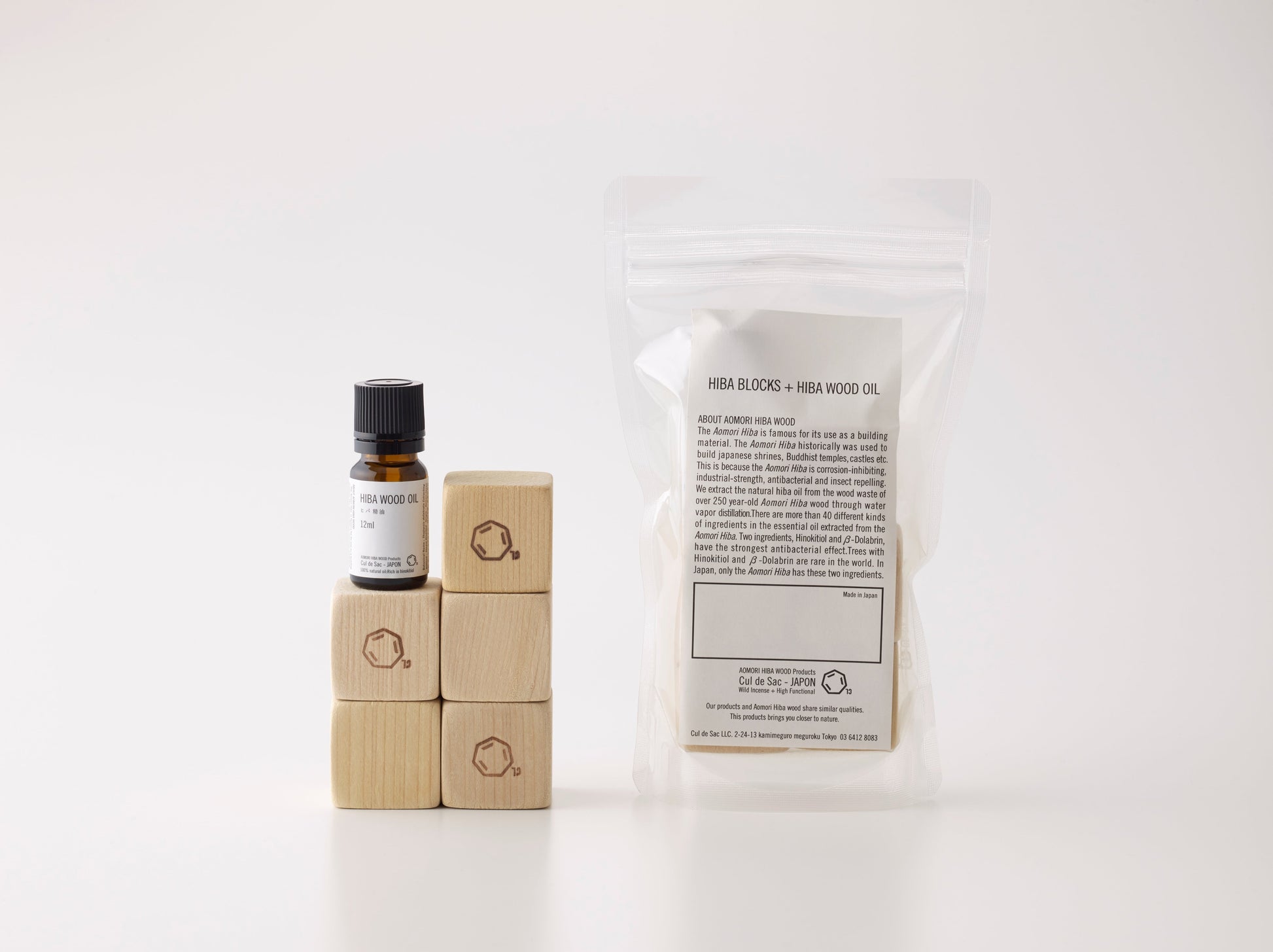 A packet of Cul de Sac hiba wood blocks and oil on a white background