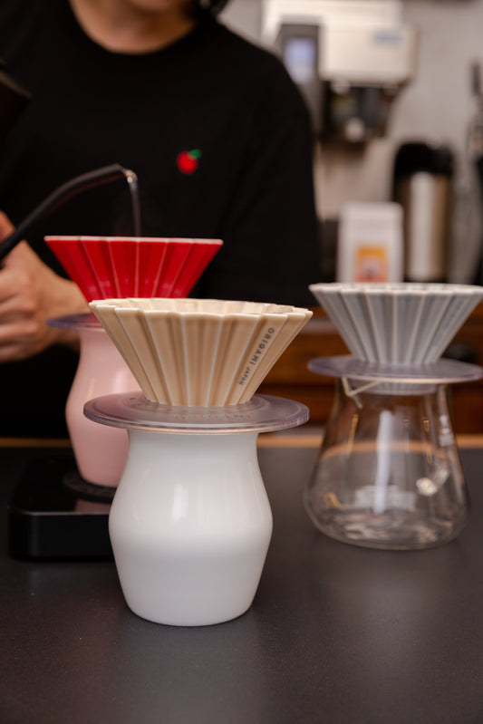 Multiple ORIGAMI coffee drippers on carafes
