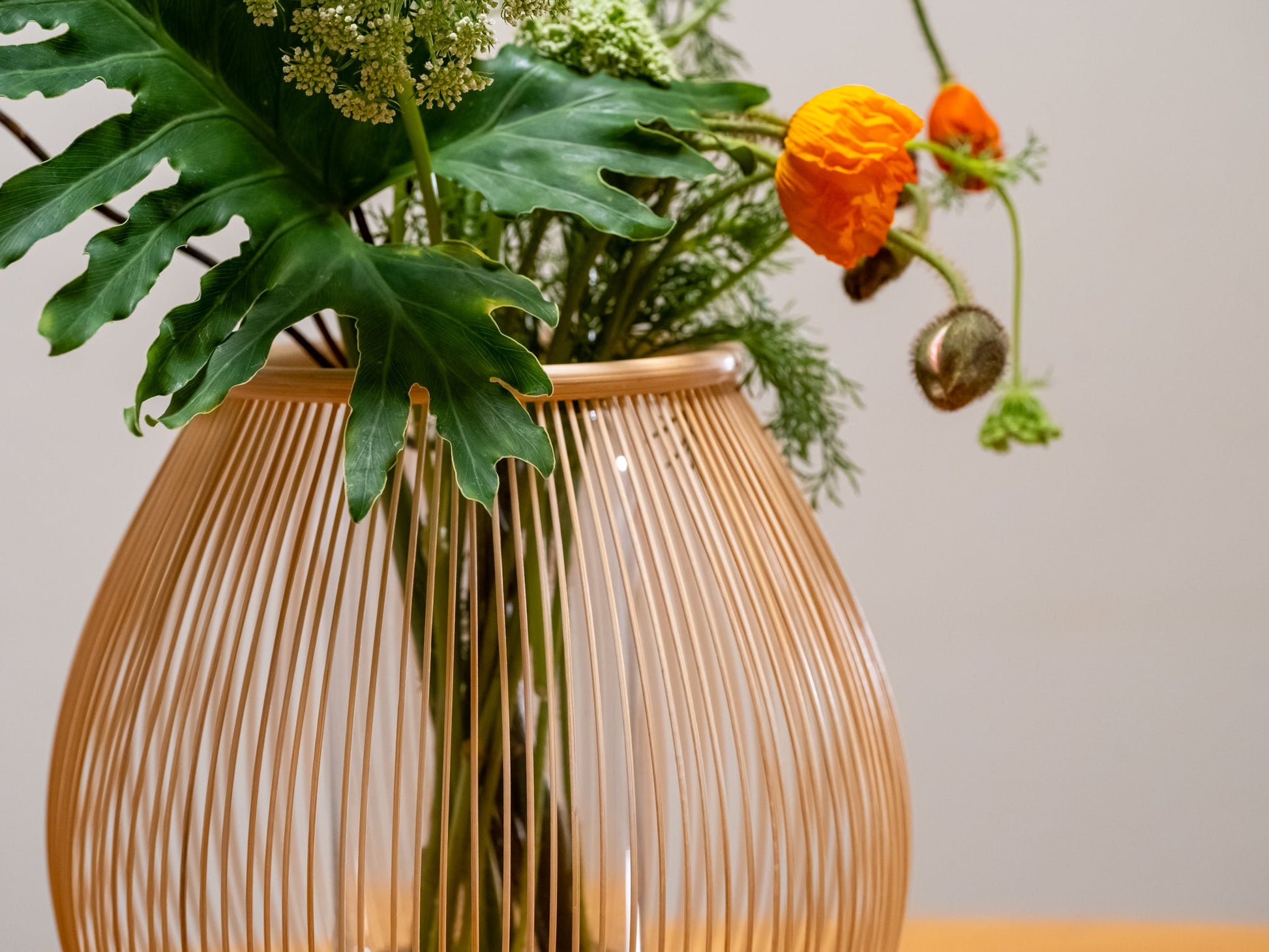 A Japanese bamboo vase with a contemporary flower arrangement
