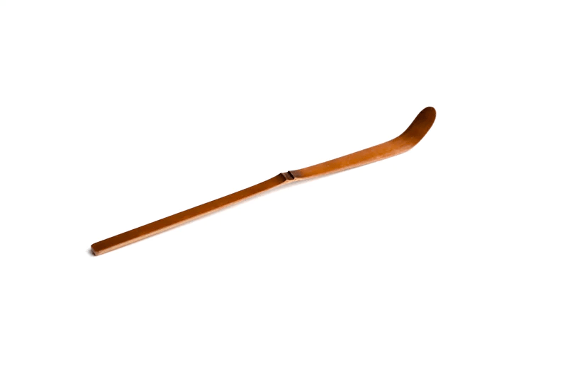A soot bamboo tea scoop on a white background