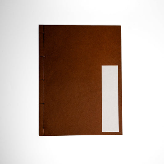 An Persimmon Kakishibuzome Awagami Factory washi paper Watoji Notebook on a white background