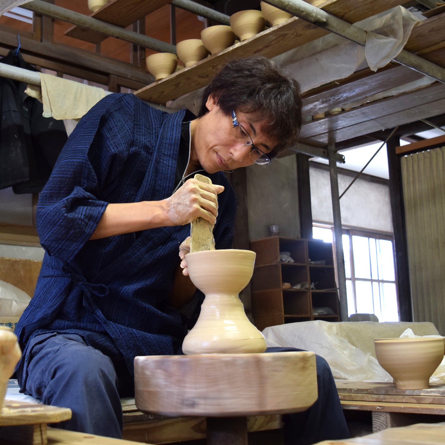 Akira Yoshiga throwing a Japanese ceramic hagi yaki bowl on a kick wheel