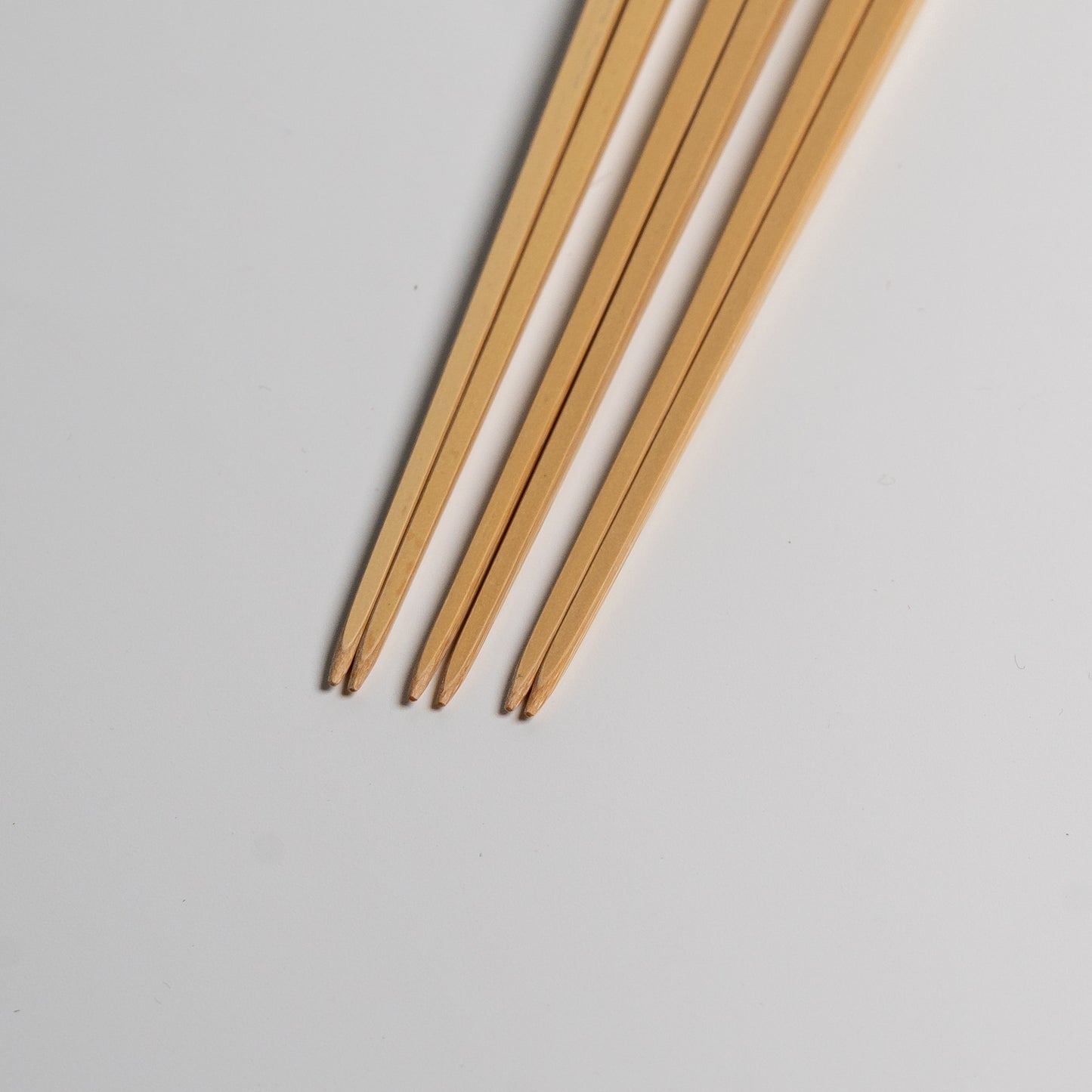 The tips of three Japanese bamboo chopsticks