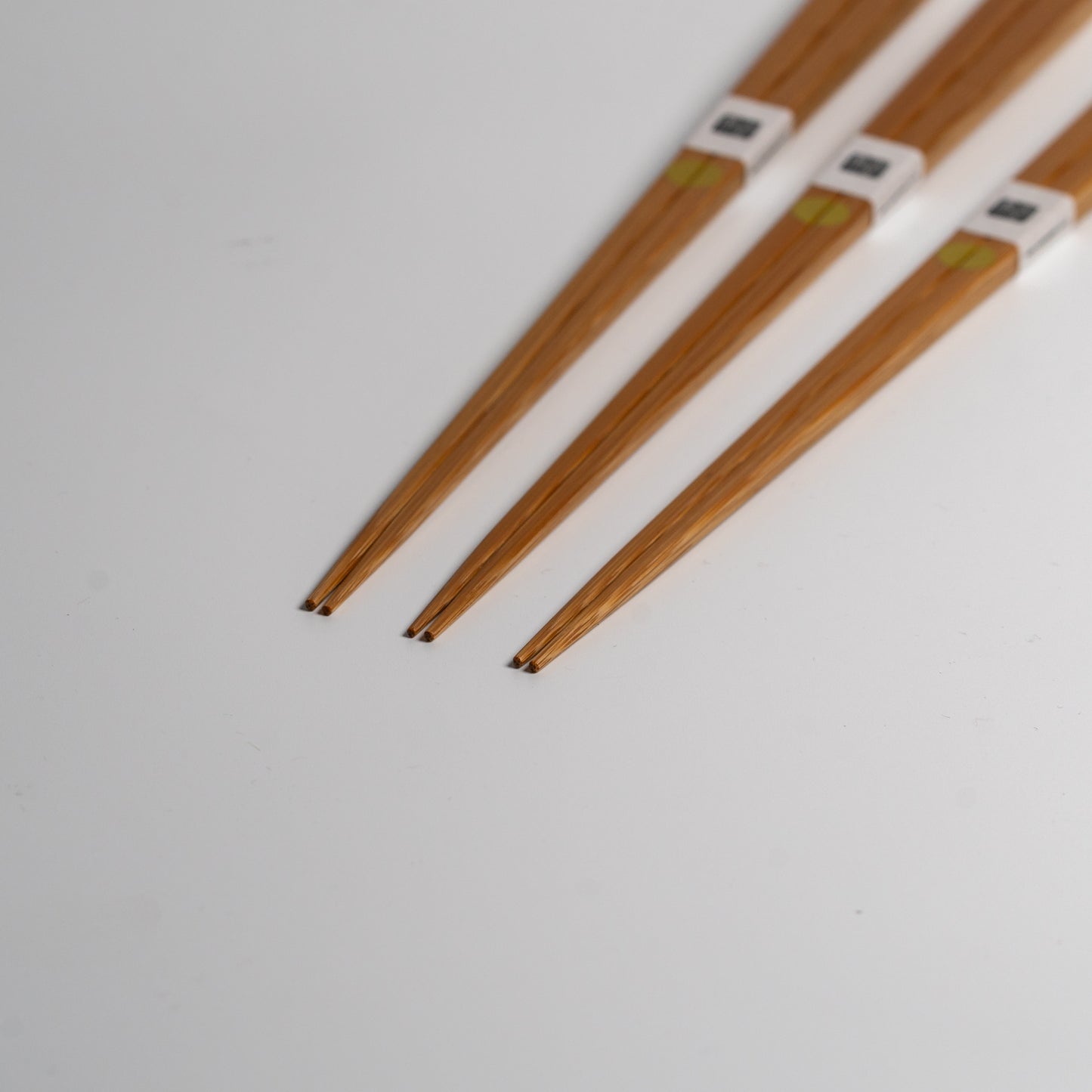 Japanese bamboo chopsticks with gold circles on white