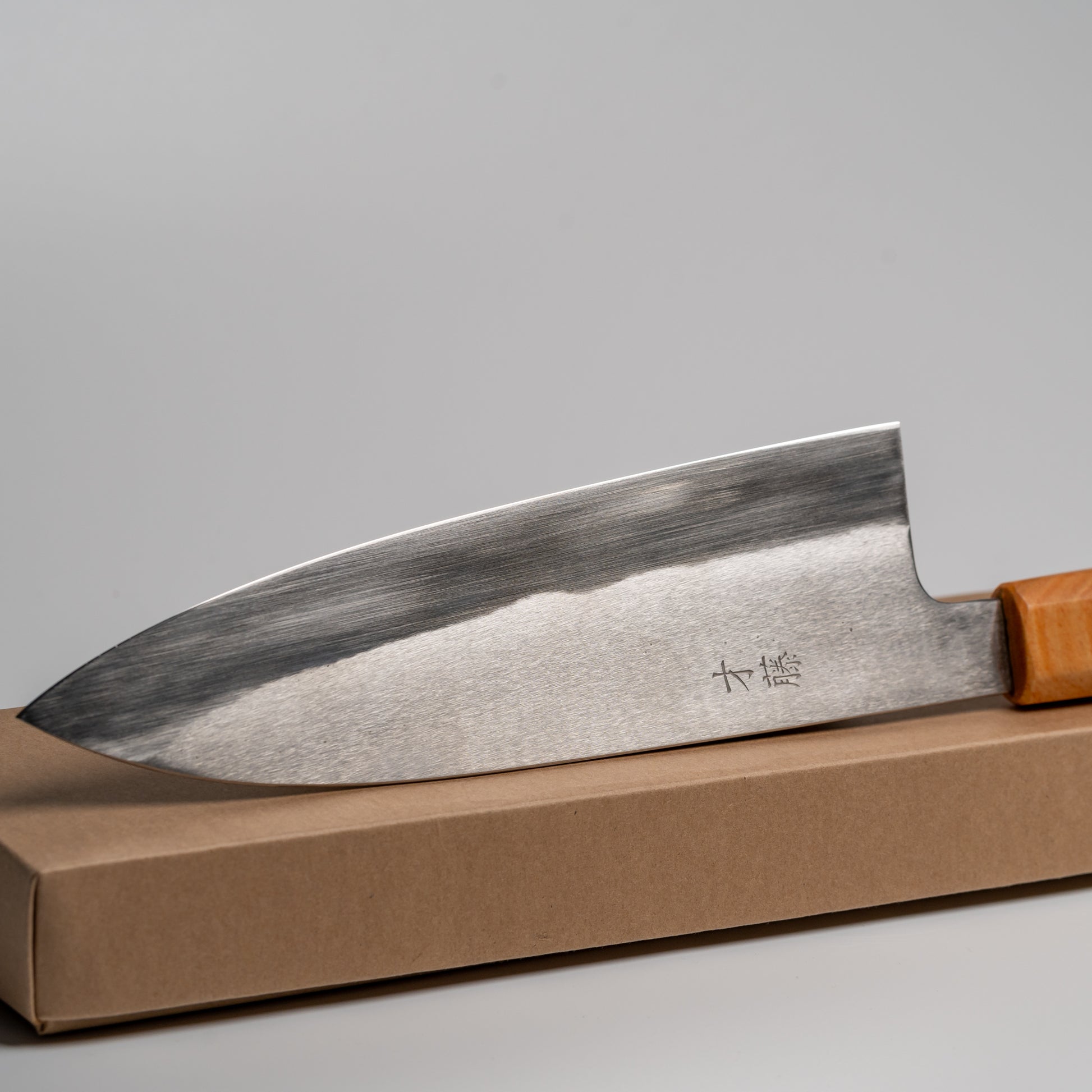 Close up of a Japanese Gyuto knife on its box