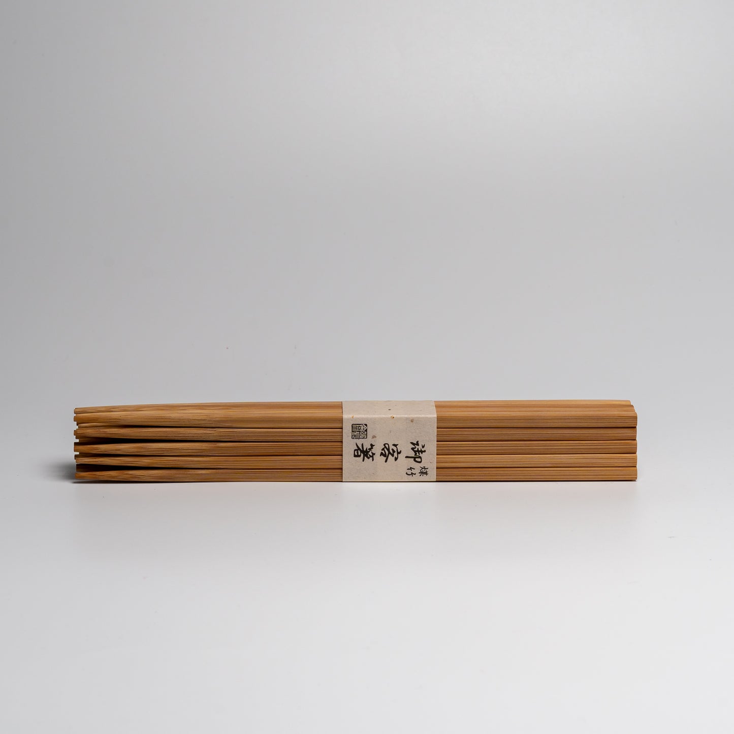 A large pack of Japanese bamboo chopsticks on white