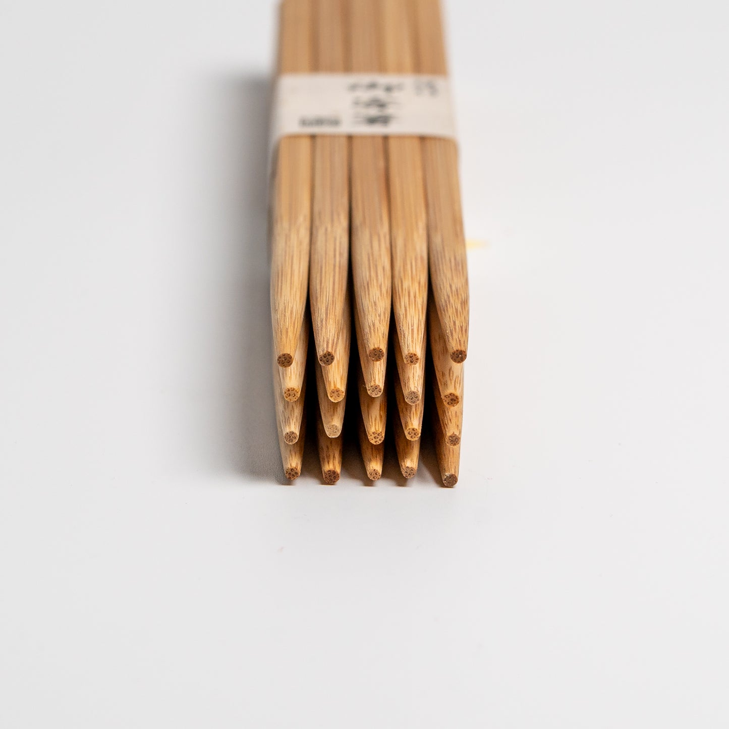 A large pack of Japanese bamboo chopsticks on white