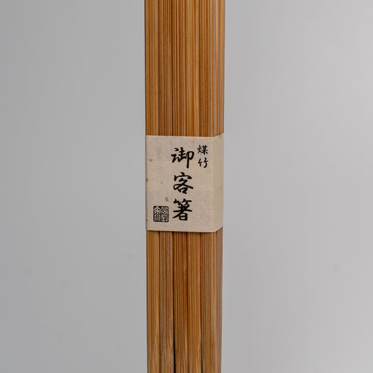 A large pack of Japanese bamboo chopsticks on white