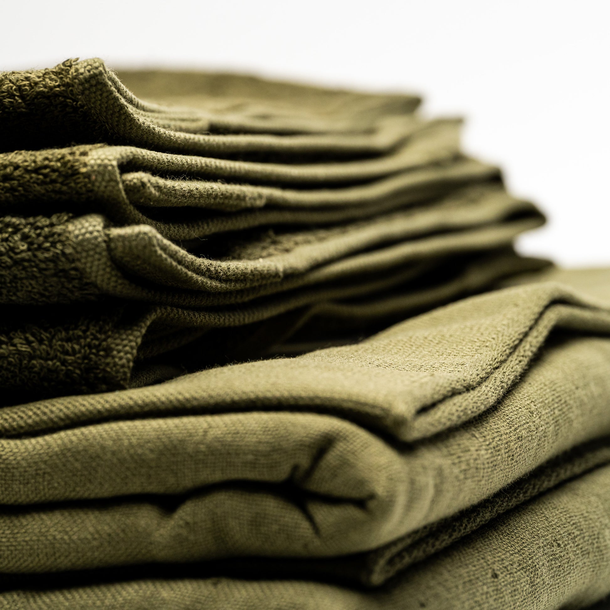 A stack of green Filhiba bath towels