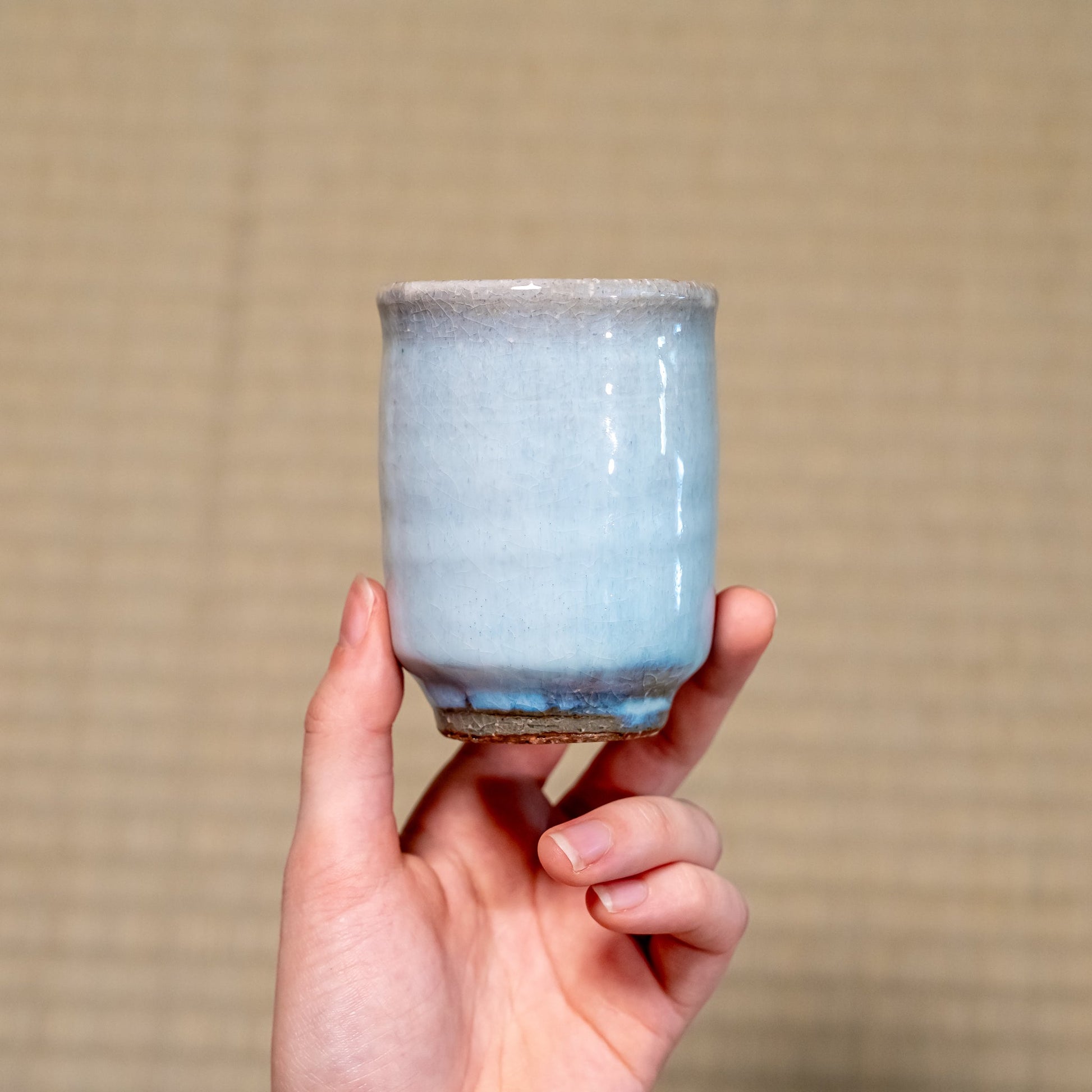 A Japanese ceramic Hagi yaki teacup held in hand