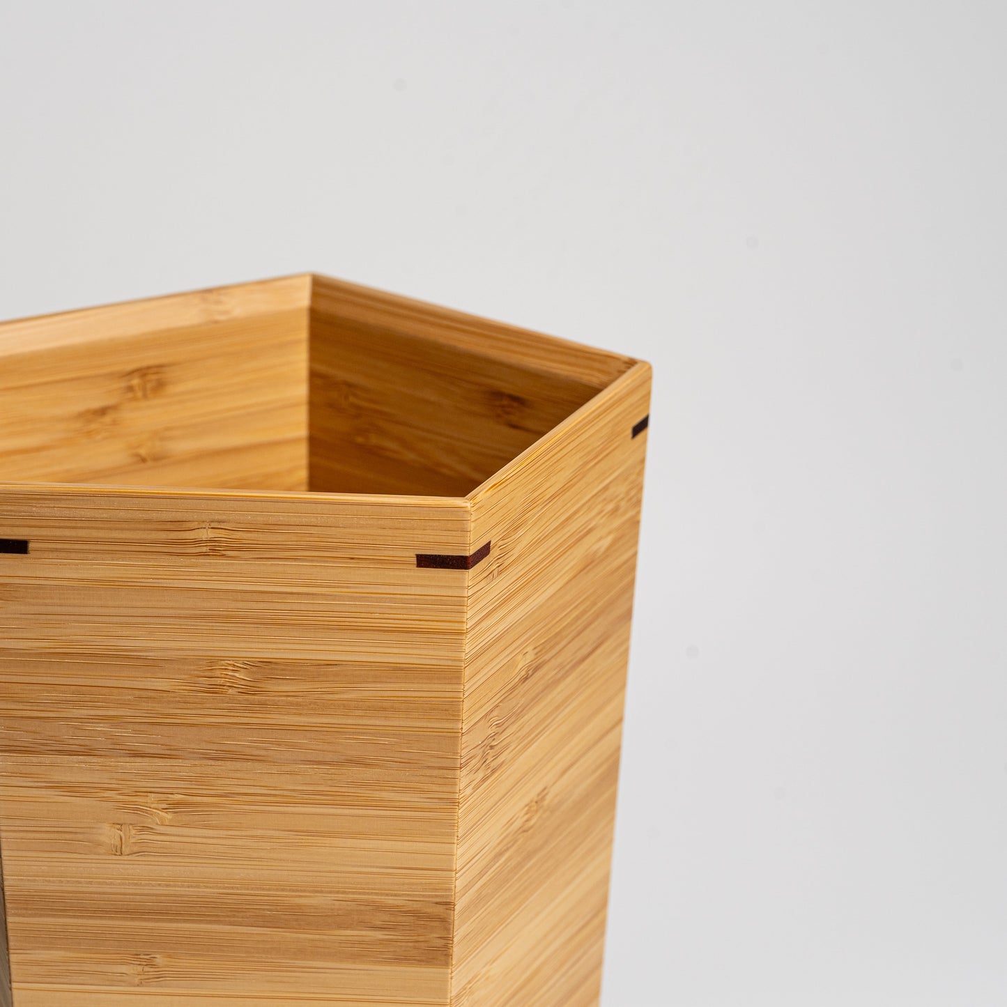 Close up of a bamboo wine cooler on a white background