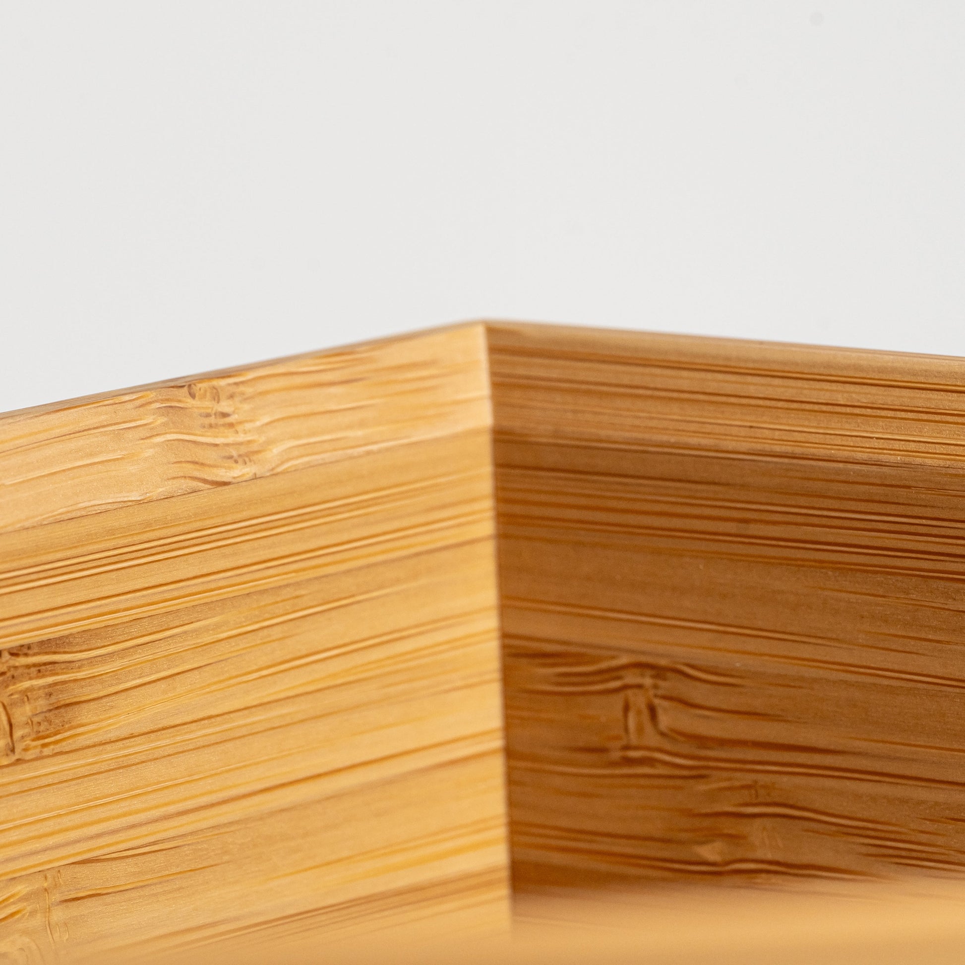 Close up of the inside of a bamboo wine cooler on a white background