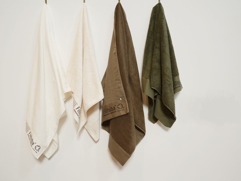 Filhiba towels hanging on a white wall