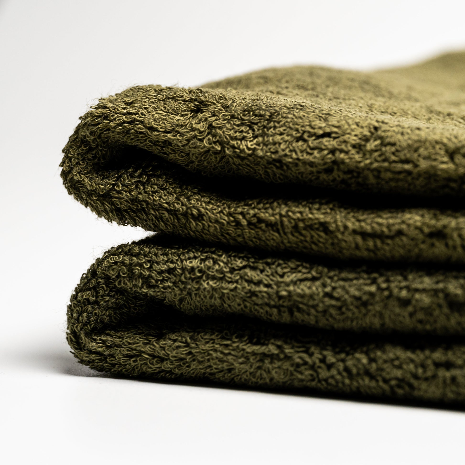 Green Filhiba face towels on a white background